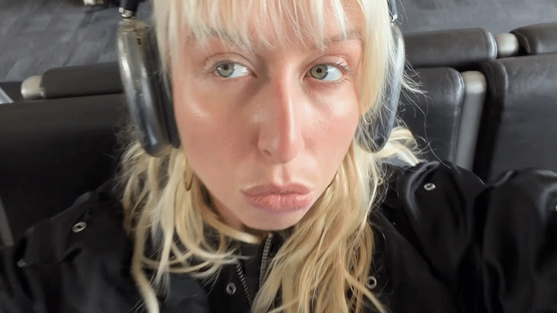 Woman waits in airport seating area in Los Angeles