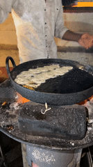 Street vendor prepares desserts and rice dishes in Bengaluru