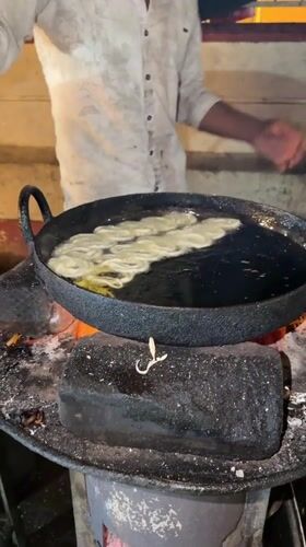 Street vendor prepares desserts and rice dishes in Bengaluru
