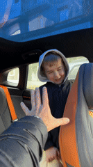 Man and boy share playful car moment in Krasnoyarsk
