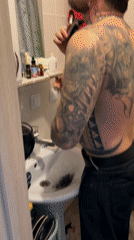 Man shaves beard in Saint Petersburg bathroom