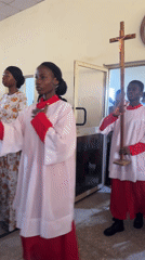 Young people in white robes hold church procession in Gandu