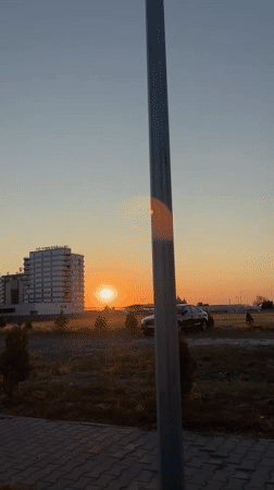 Golden sunset light over Năvodari's modern residential streetscape