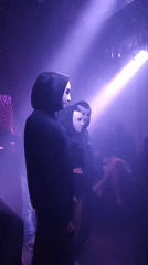 Masked performance with purple lighting in Yekaterinburg nightclub