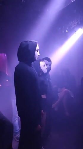 Masked performance with purple lighting in Yekaterinburg nightclub