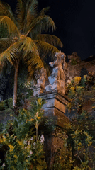Nighttime temple statues illuminated in Ubud, Bali