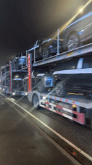 Car carrier truck transports new vehicles through Russian town