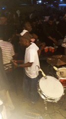 Live band performs at crowded outdoor nighttime party venue