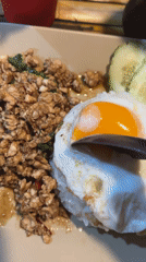 Traditional Thai rice dish with fried egg documented in Ratsada