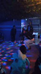 Social Dancing Gathering Features Disco Lights and Group Activities