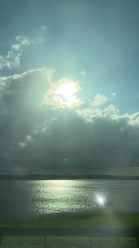 Sunbeams over lake captured from vehicle in Linevo, Russia