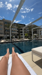 Person enjoys poolside relaxation at Tivat resort facility