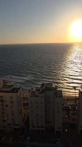 Kitesurfers enjoy golden hour session off Bat Yam coast