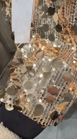 Person films sequined outfit try-on in Esenyurt mirror selfie