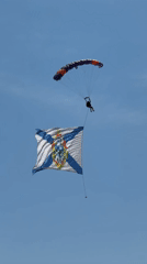 Skydiver descends with flag over Ussurijsk, Russia