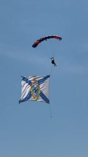 Skydiver descends with flag over Ussurijsk, Russia