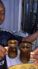 Men share traditional tea service at Nigeria stadium