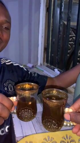 Men share traditional tea service at Nigeria stadium