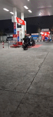 Nighttime fuel stop and road traffic in Southeast Asia