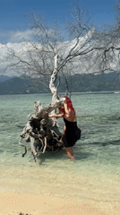 Woman explores shallow Indonesian waters at dawn