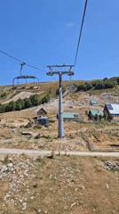 Off-season mountain resort day with ski lifts, goats, and coffee