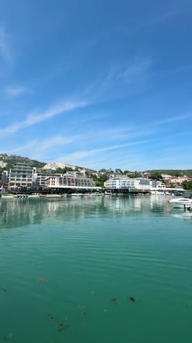 Tourist documents sunny marina views in Balchik, Bulgaria