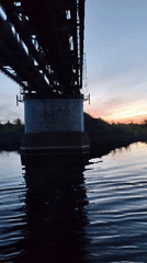 Railway bridge documented at twilight in rural Russia