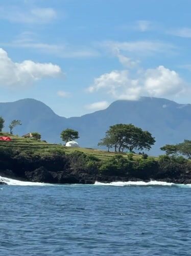 Boat passenger captures coastal scenery near Karangasem, Indonesia
