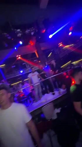 Late-night club scene in Smolyan under colored lights
