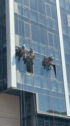 Workers perform rope maintenance on Krasnoyarsk high-rise building