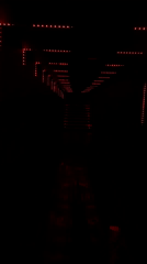 Red-lit tunnel hallway captured in Playa del Carmen