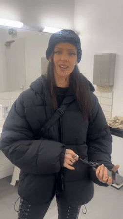 Woman takes mirror selfies in Berlin public restroom