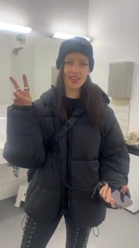 Woman takes mirror selfies in Berlin public restroom