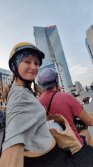 Woman films selfie video while riding scooter in Hà Nội