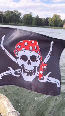 Afternoon boat trip on a Potsdam lake, pirate flag flying