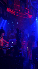 Nightclub scene captured in Tianhe District with DJ, dancers