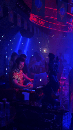 Nightclub scene captured in Tianhe District with DJ, dancers