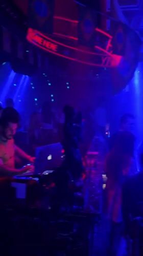 Nightclub scene captured in Tianhe District with DJ, dancers