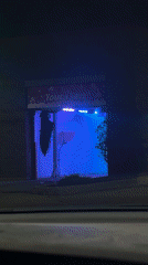 Naperville car wash displays colorful lighting sequence during nighttime operation