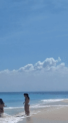 Red flag up, waves breaking at a rocky tropical beach