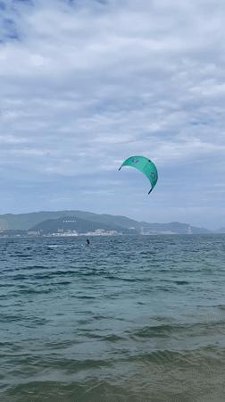 Nha Trang beachfront morning: kitesurfing, cycling, and shoreside downtime