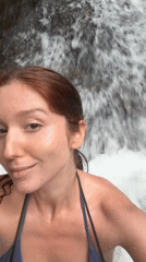 Tourists swim and photograph at Ban Bang Khli waterfall