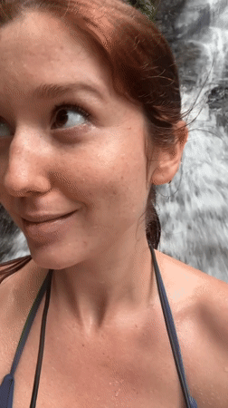Tourists swim and photograph at Ban Bang Khli waterfall