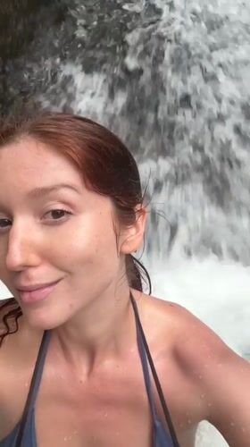Tourists swim and photograph at Ban Bang Khli waterfall