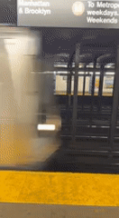 NYC subway train arrives at station during late night hours