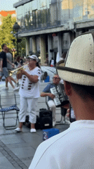 Brass band plays Belgrade streets as café crowds look on
