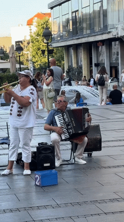 Brass band plays Belgrade streets as café crowds look on