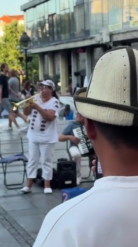 Brass band plays Belgrade streets as café crowds look on