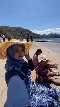 Family enjoys sunny beach day in Indonesia