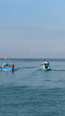 Fishing boats out on the water off Lý Sơn Island